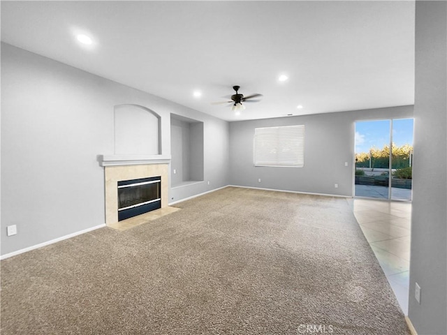 unfurnished living room featuring carpet flooring and ceiling fan