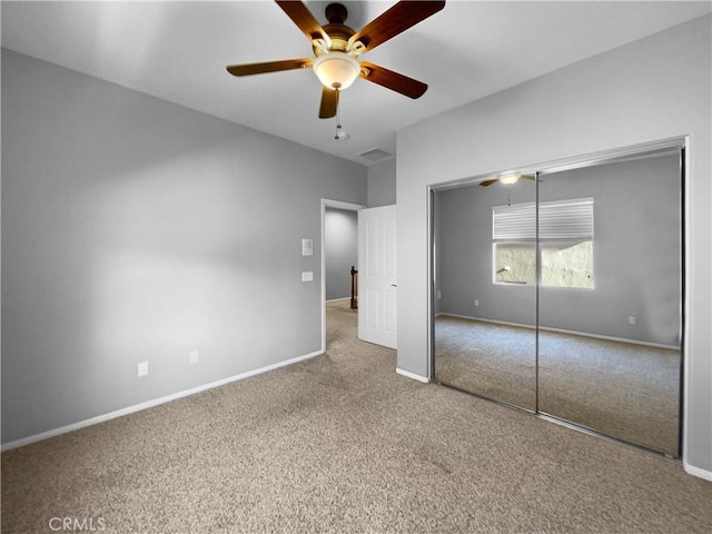 unfurnished bedroom with carpet floors, a closet, and ceiling fan