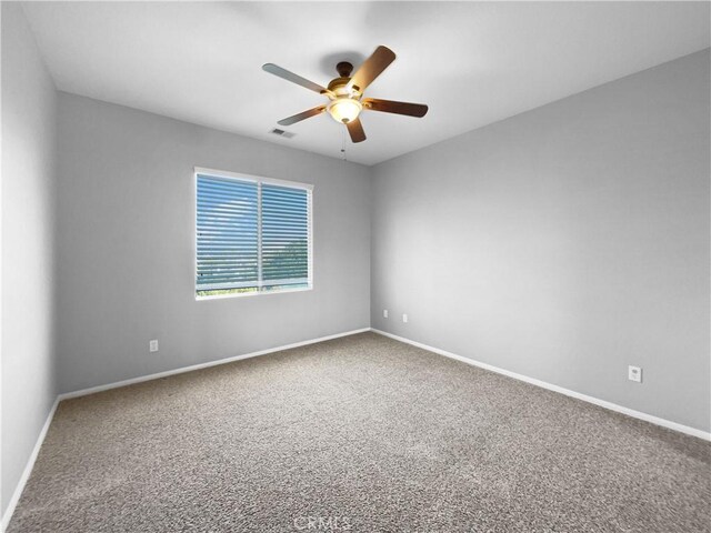 spare room featuring carpet floors and ceiling fan