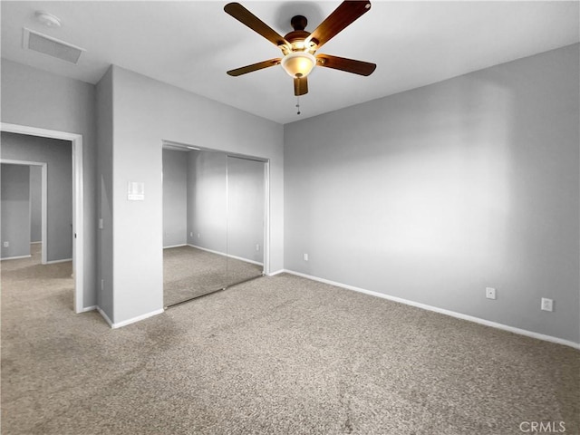 unfurnished bedroom with carpet, ceiling fan, and a closet