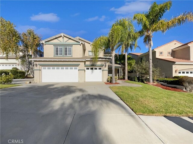 view of front of property with a garage and a front yard