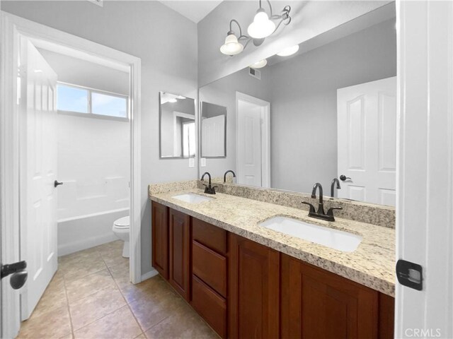 full bathroom featuring tile patterned floors, vanity,  shower combination, and toilet