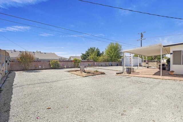 view of yard featuring a storage unit and a patio area