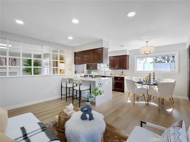 living room featuring sink and light wood-type flooring