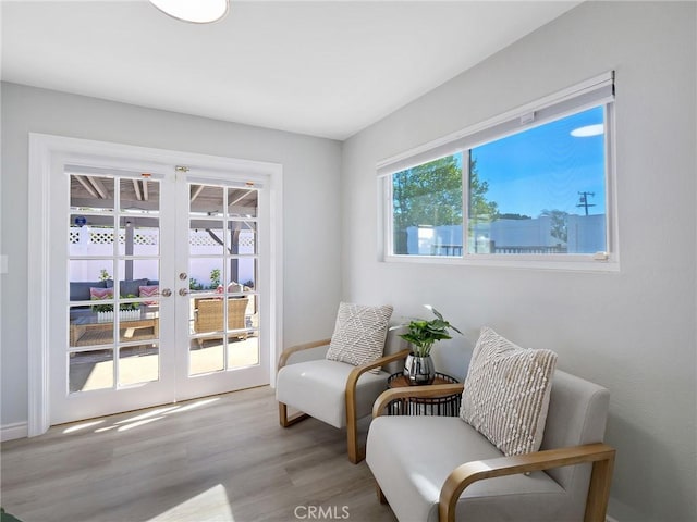 sitting room featuring light hardwood / wood-style flooring and french doors