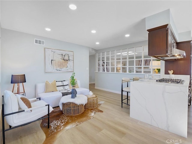 sitting room featuring light hardwood / wood-style floors