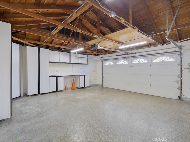 garage featuring a garage door opener and wood ceiling