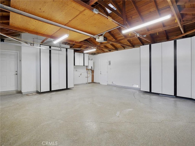 garage with a garage door opener, wood ceiling, and water heater