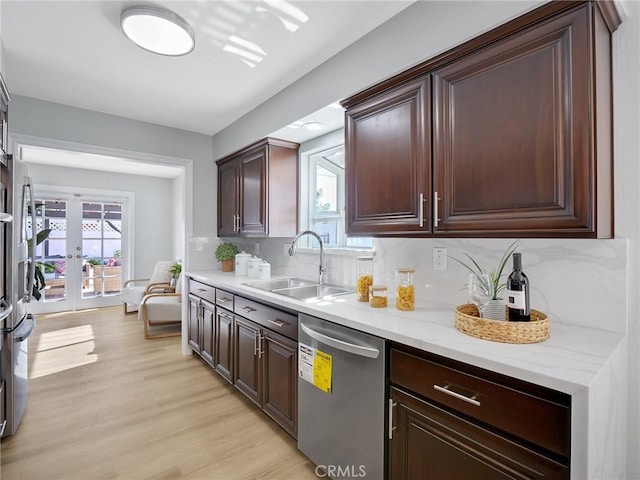 kitchen with dishwasher, french doors, sink, backsplash, and light hardwood / wood-style floors