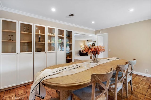 dining space with light parquet floors and ornamental molding