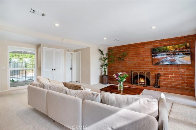 living room featuring light colored carpet and a brick fireplace