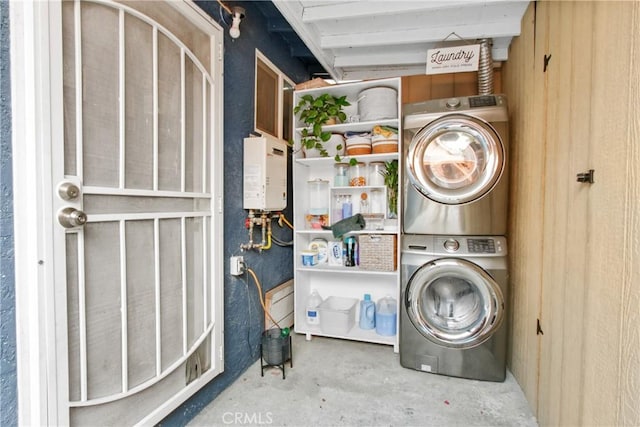 laundry area with stacked washer and clothes dryer and water heater