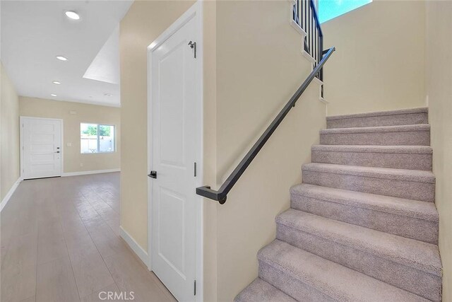 stairway with hardwood / wood-style floors