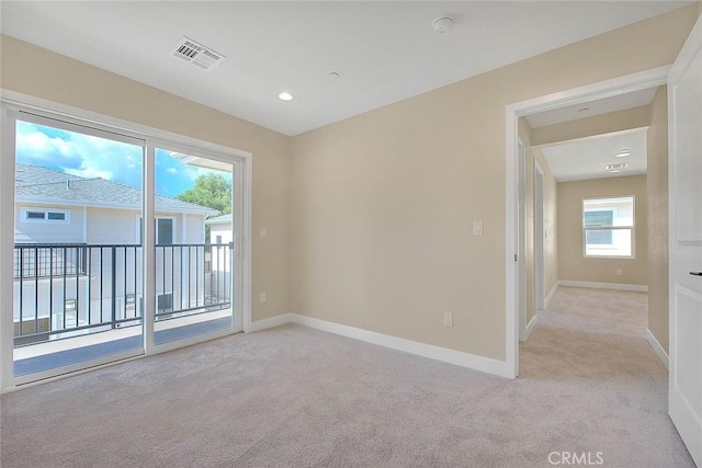 carpeted empty room with plenty of natural light