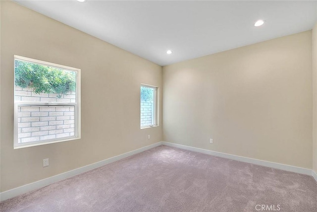 carpeted spare room featuring a healthy amount of sunlight