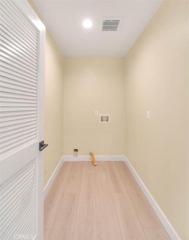 washroom with hookup for a washing machine, light hardwood / wood-style floors, and gas dryer hookup