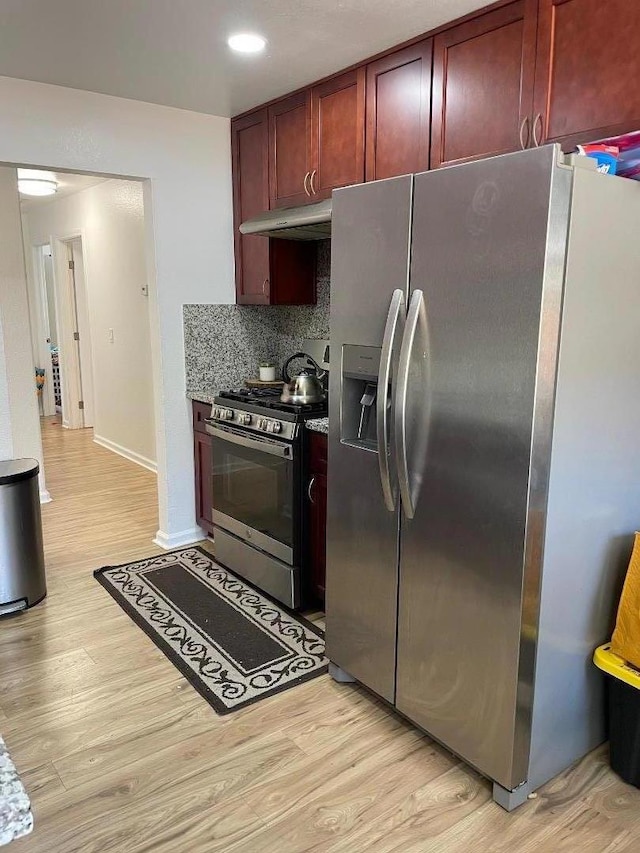 kitchen featuring tasteful backsplash, light hardwood / wood-style flooring, and stainless steel appliances