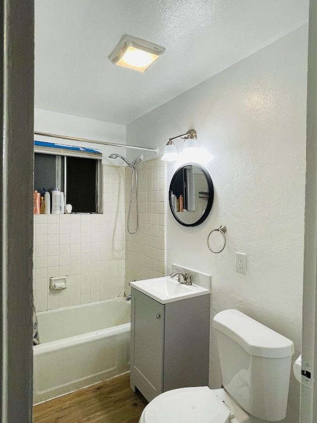 full bathroom featuring vanity, toilet, tiled shower / bath, and hardwood / wood-style flooring