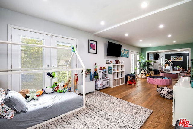 bedroom featuring hardwood / wood-style floors and french doors