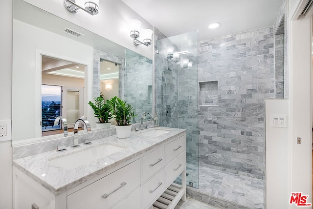 bathroom with vanity and tiled shower