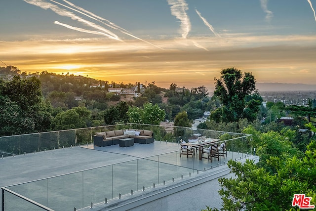 view of sport court featuring a patio area and an outdoor hangout area