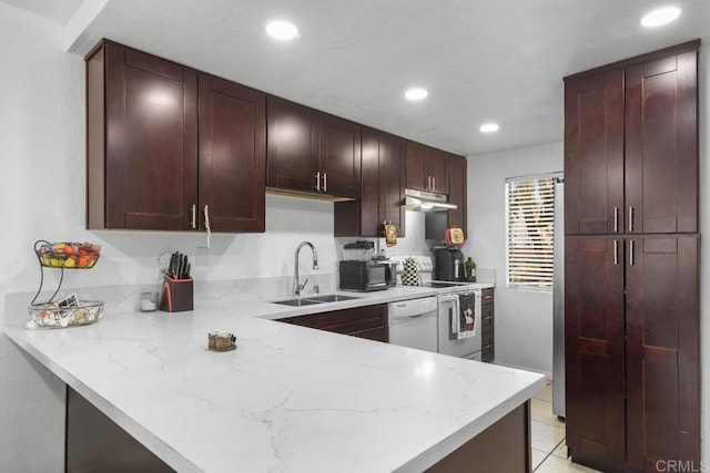 kitchen with kitchen peninsula, light stone counters, white appliances, sink, and light tile patterned floors