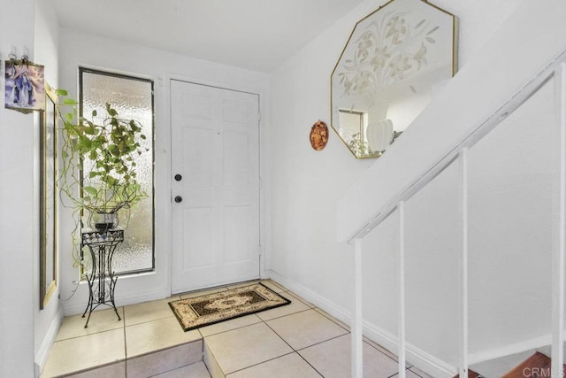 foyer entrance with light tile patterned flooring