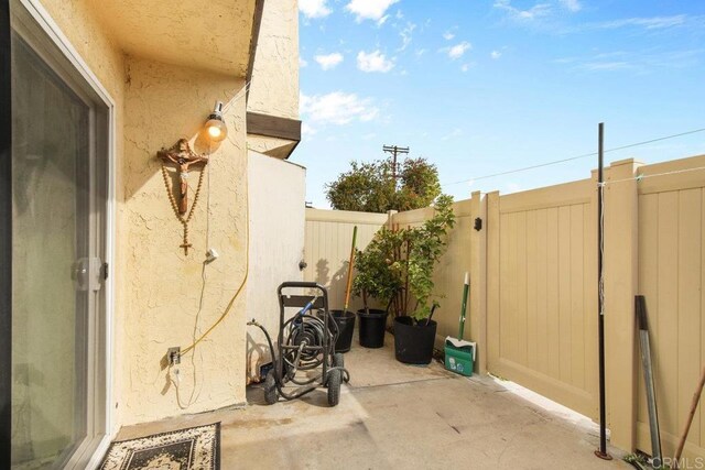 view of patio / terrace featuring fence