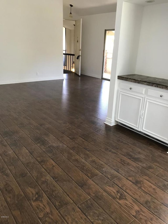 spare room with dark wood-type flooring