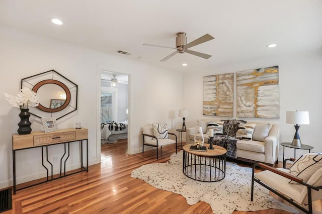 living room with ceiling fan and hardwood / wood-style floors