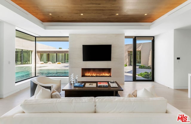 living room with a fireplace and wooden ceiling