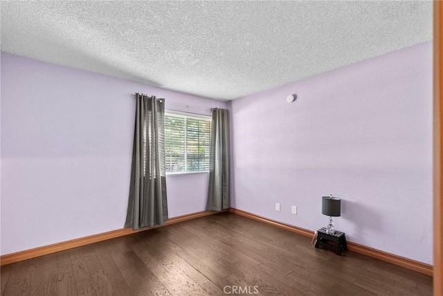 unfurnished room with hardwood / wood-style floors and a textured ceiling