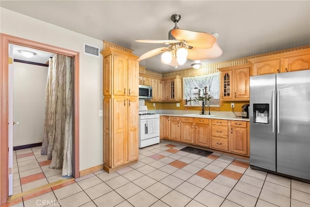 kitchen featuring sink, ceiling fan, appliances with stainless steel finishes, and light tile patterned flooring