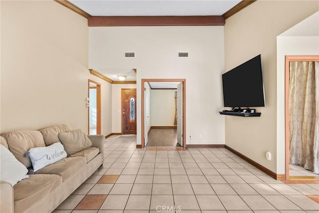 tiled living room featuring a towering ceiling and crown molding