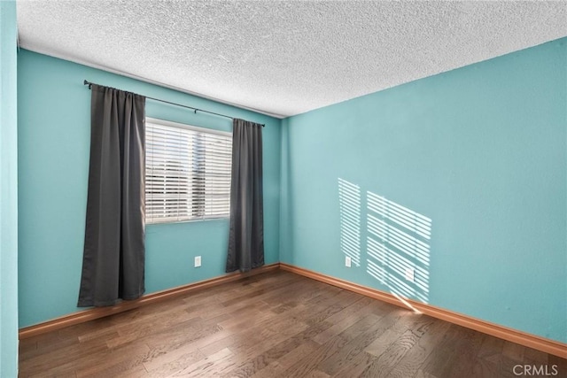 unfurnished room featuring a textured ceiling and hardwood / wood-style floors