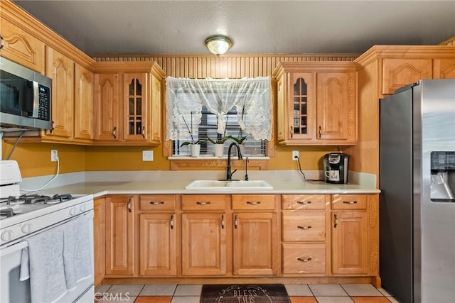 kitchen featuring light tile patterned floors, sink, and appliances with stainless steel finishes