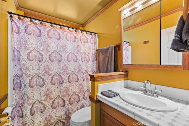 bathroom featuring vanity, toilet, and ornamental molding