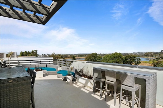 view of patio with a pergola, a water view, and an outdoor hangout area