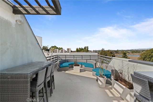 view of patio / terrace with an outdoor living space and a balcony