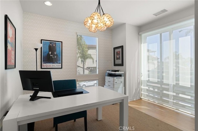 office area with an inviting chandelier and light wood-type flooring