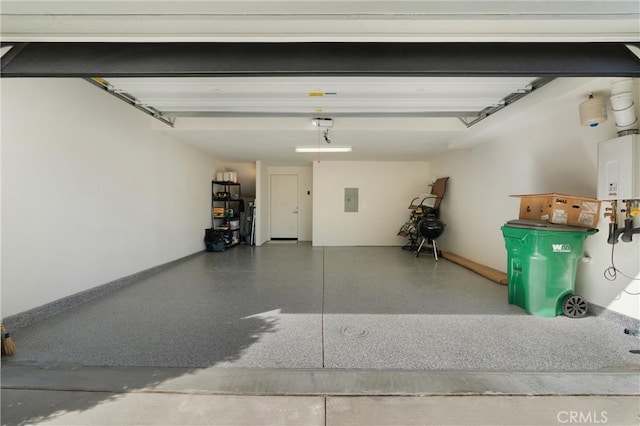 garage featuring electric panel and water heater