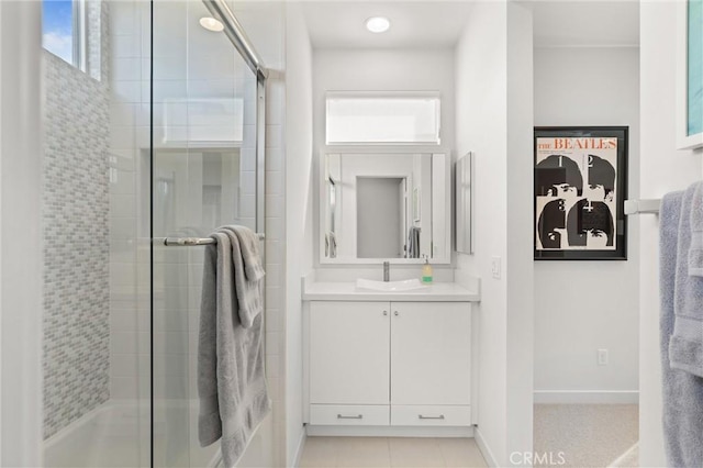 bathroom with a shower with door and vanity