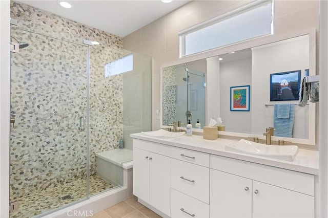 bathroom featuring tile patterned flooring, vanity, and walk in shower