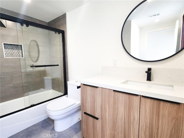 full bathroom with toilet, combined bath / shower with glass door, and vanity