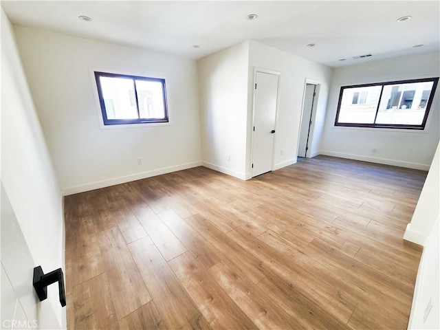 unfurnished room with light hardwood / wood-style floors