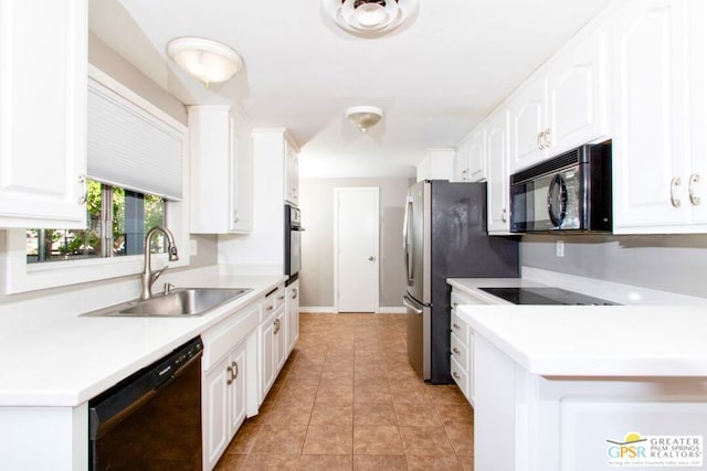 kitchen with light tile patterned floors, sink, white cabinetry, and black appliances