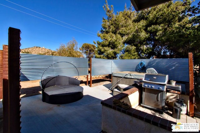 view of patio featuring grilling area and a hot tub