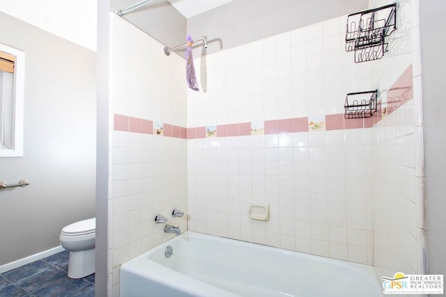 bathroom with tile patterned floors, toilet, and tiled shower / bath