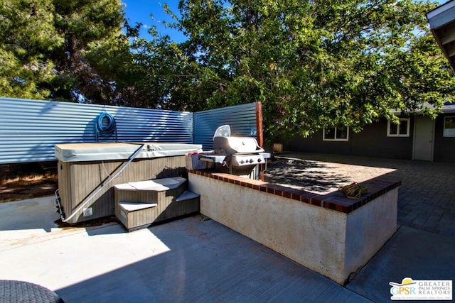 view of patio / terrace featuring area for grilling and a hot tub