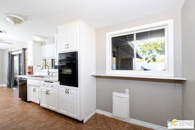 kitchen with white cabinets, sink, a wealth of natural light, and black appliances